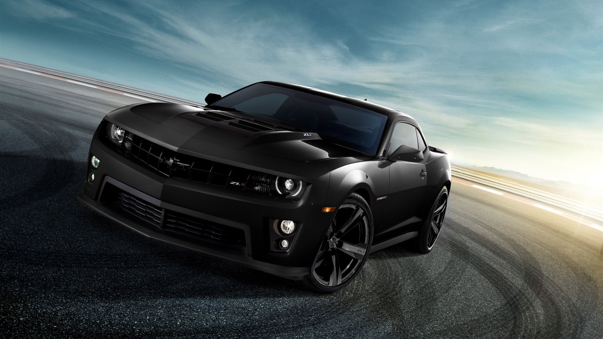 Wallpaper #VXOyhI4BFI5NbQksFx2H25 A Black Chevrolet Camaro Ss on an Asphalt Road with a Blurred Background