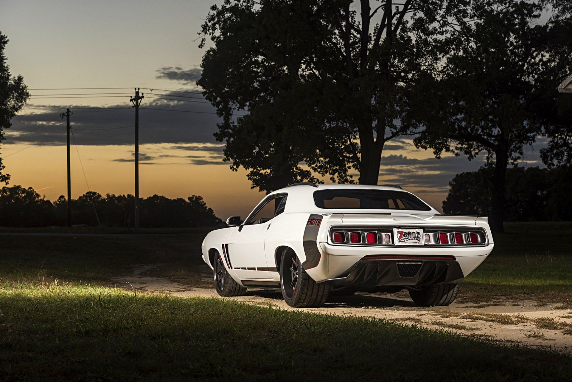 Wallpaper #lnOZg44BFI5NbQks9htG26 A Classic Muscle Car, the Plymouth Barracuda, is Parked in a Field at Sunset