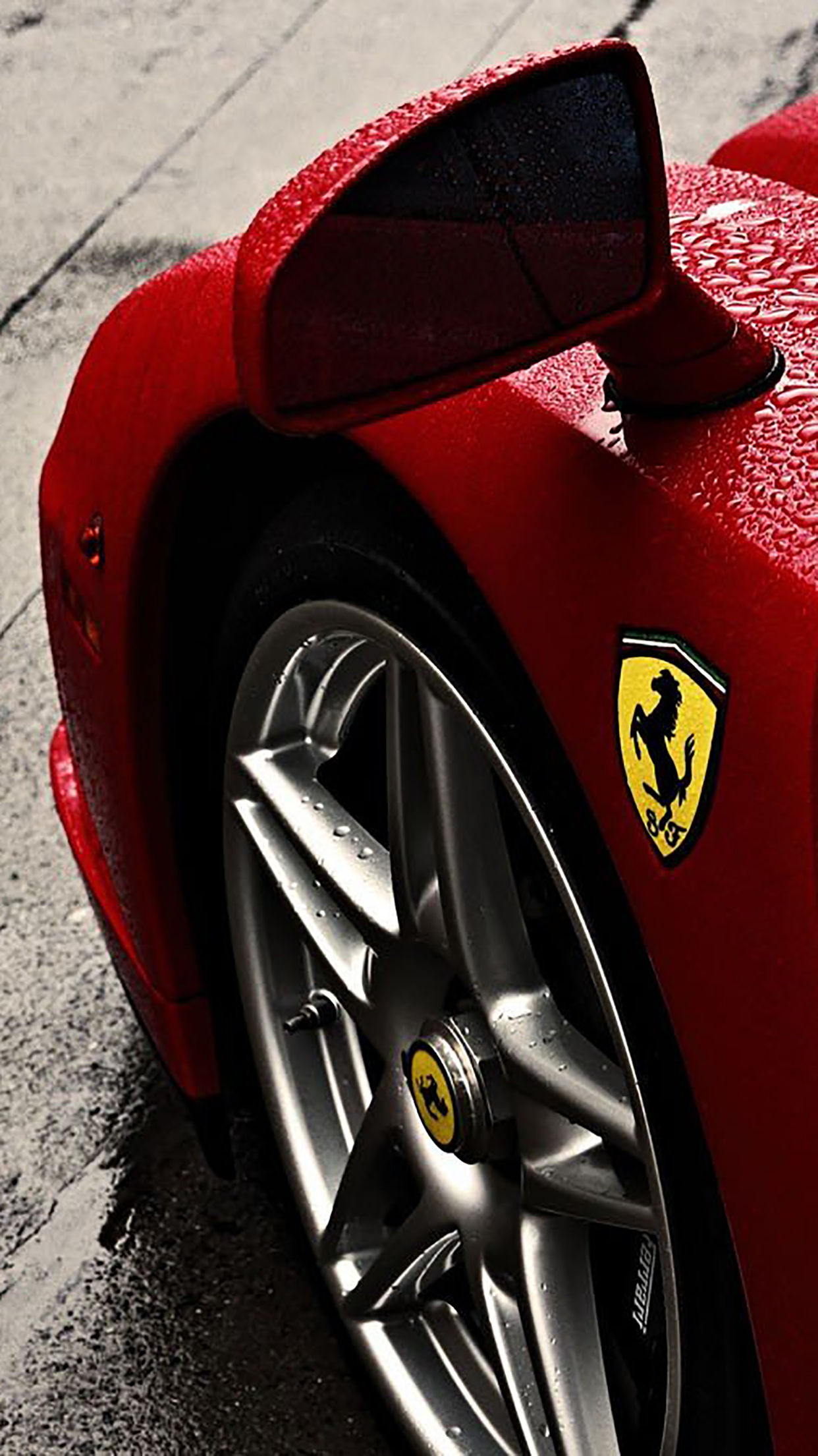 Wallpaper #JEUIr44B7YBJg1BVAaom40 A Sleek Red Ferrari Parked on a Rainy Street