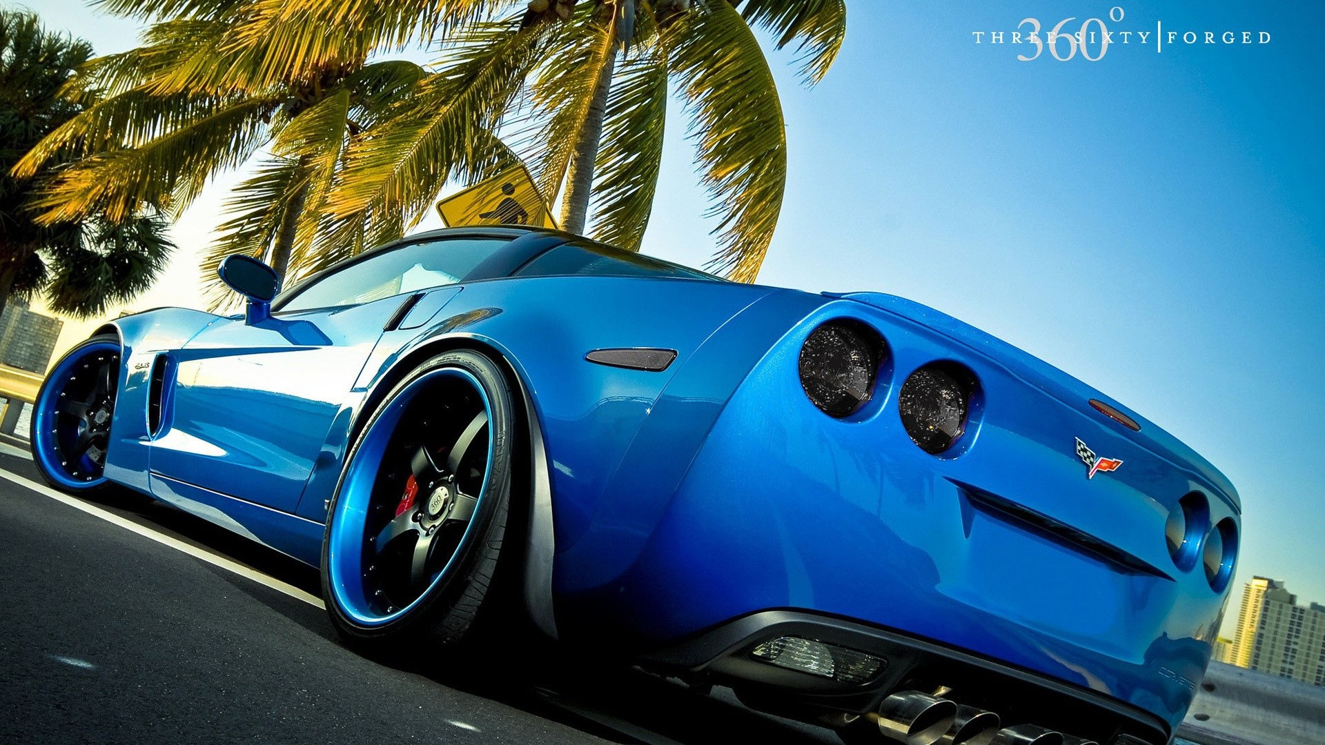 Wallpaper #RHOogI4BFI5NbQksfhj433 A Blue Chevrolet Corvette C6 Parked on a Sunny Street