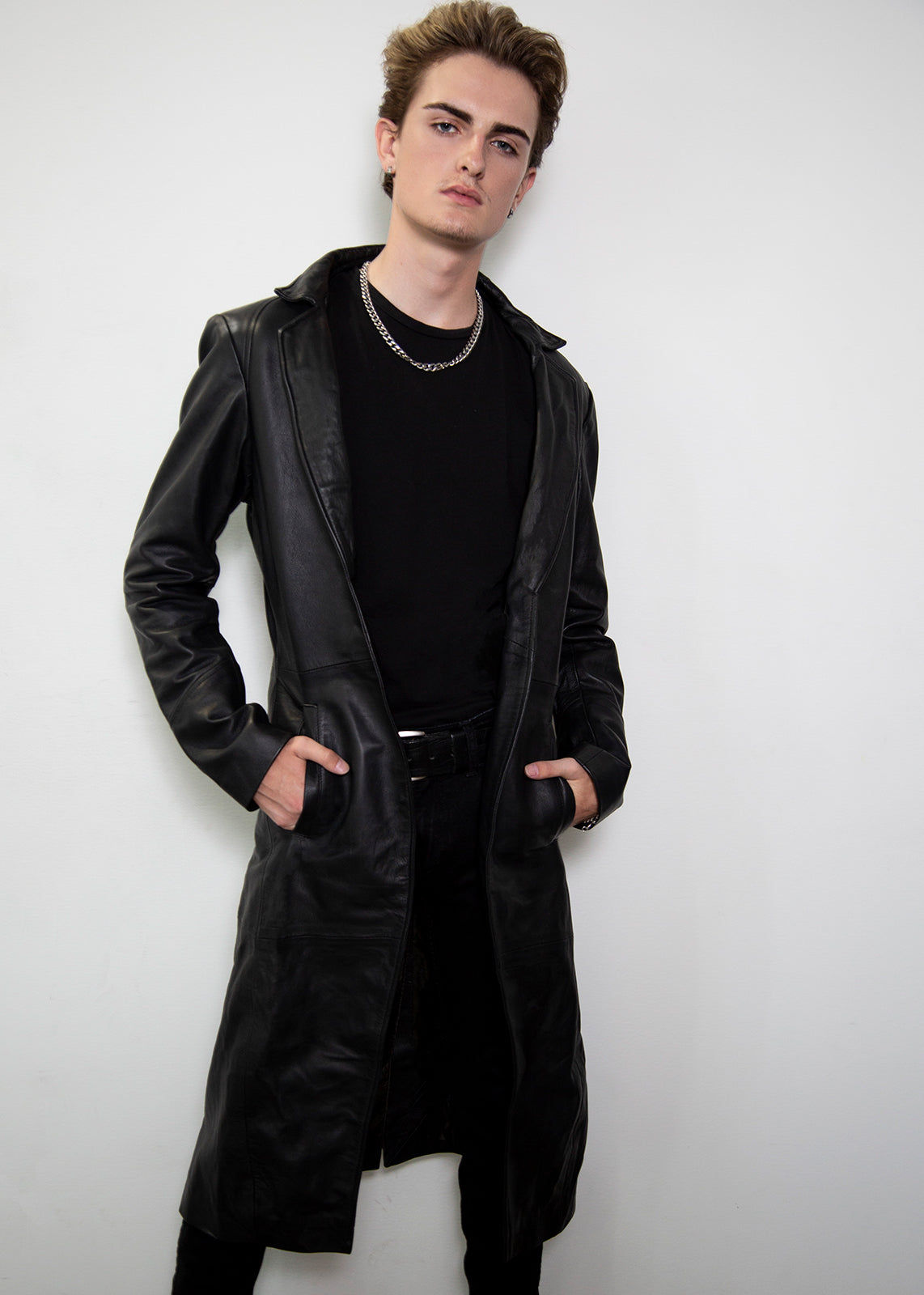 Wallpaper #PUXNk44B7YBJg1BVdZ8J25 A Young Man Wearing a Long Black Leather Coat