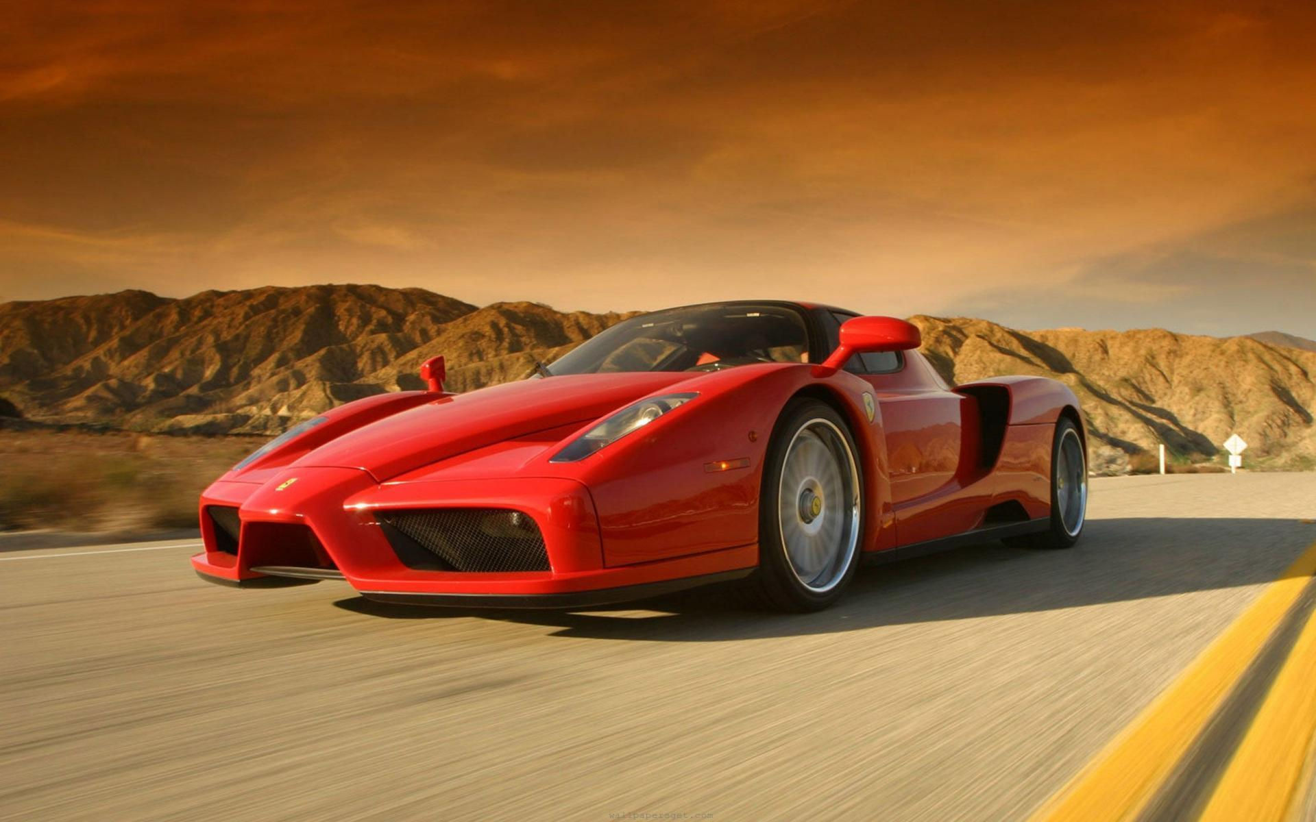 Wallpaper #JEUIr44B7YBJg1BVAaom3 A Red Ferrari Enzo Speeds Along a Winding Road
