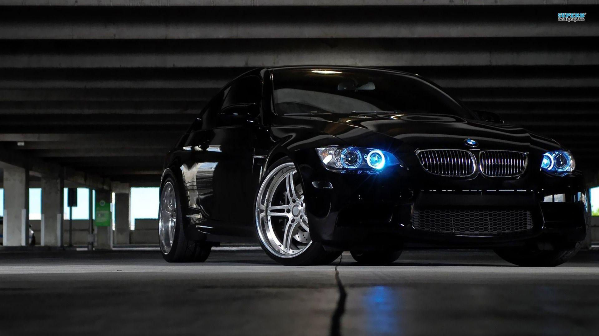 Wallpaper #z0X9ko4B7YBJg1BVTJ5P58 A Black BMW M3 E92 with Blue Headlights is Parked in a Dark Parking Garage