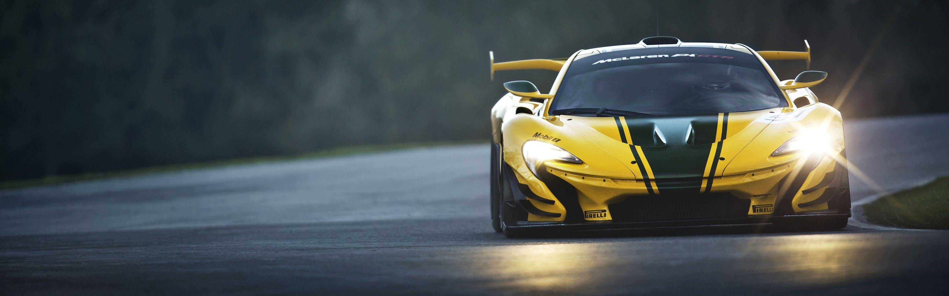 Wallpaper #aXMSg44BFI5NbQksNBlQ31 A Yellow Mclaren P1 GTR Race Car Speeds Down a Dark and Wet Track
