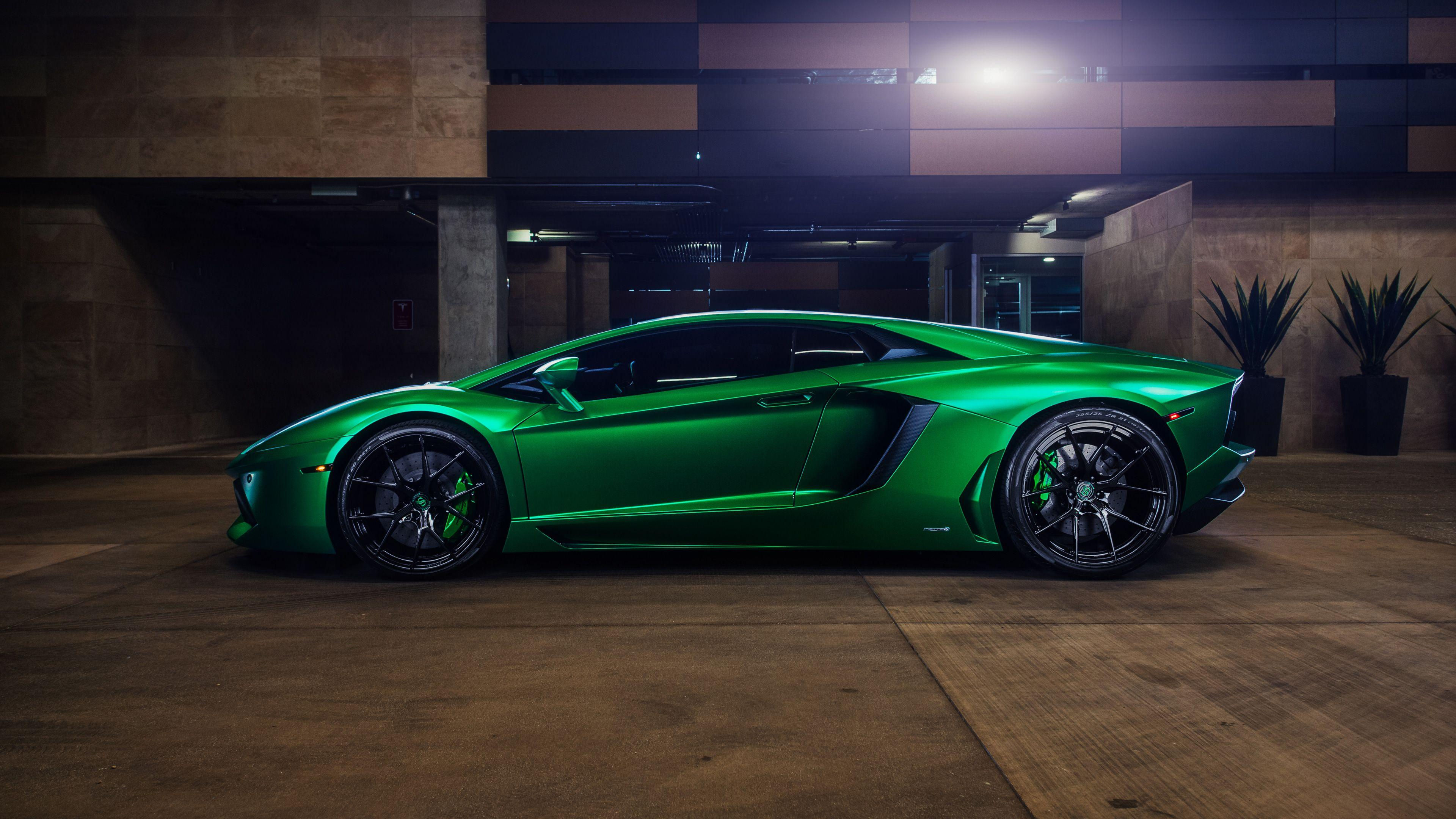 Wallpaper #-nP_iI4BFI5NbQks_iGJ12 A Green Lamborghini Aventador SVJ Parked in a Parking Garage