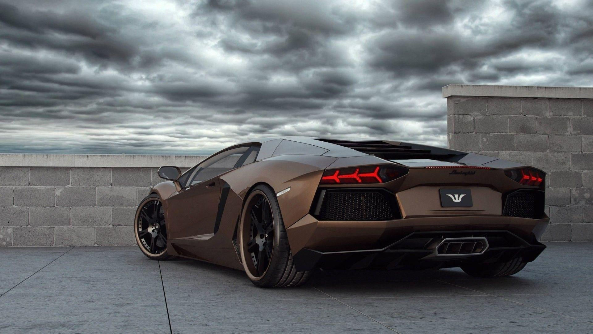 Wallpaper #6HOoiI4BFI5NbQksoSFu22 A Sleek Brown Lamborghini Aventador Parked on a Rooftop with a Stormy Sky in the Background