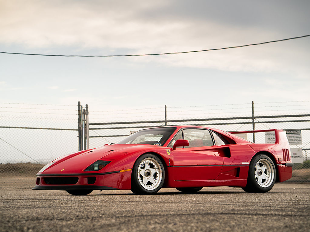 Wallpaper #K3OBh44BFI5NbQksaSEI8 A Sleek Red Ferrari F40 Parked on an Airport Runway