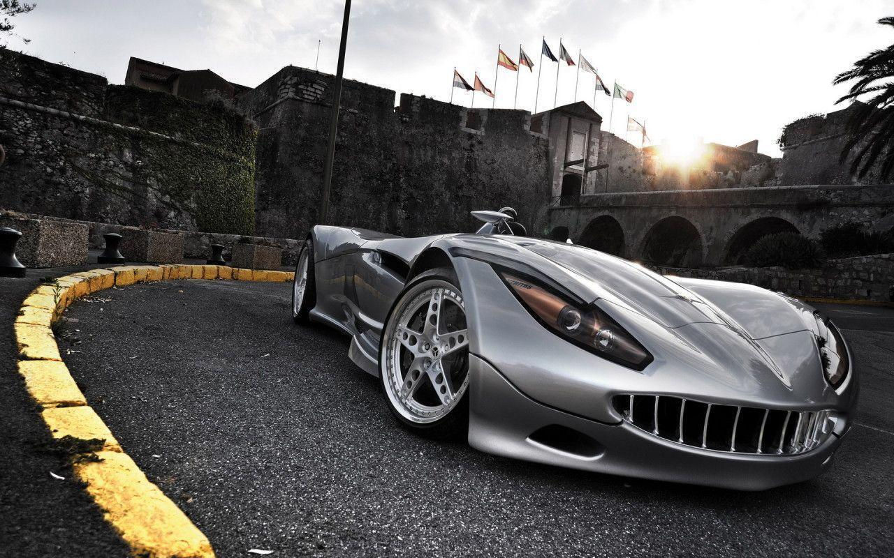 Wallpaper #IkWYk44B7YBJg1BV-59B57 A Silver Sports Car Parked in Front of a Castle