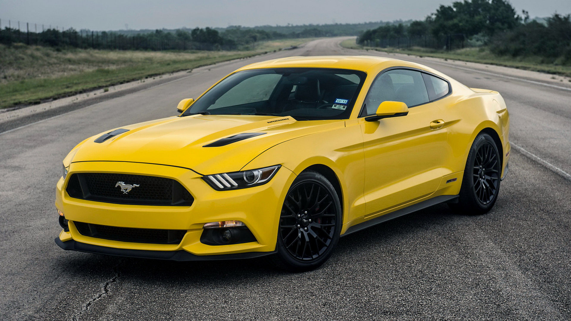 Wallpaper #OHOFgI4BFI5NbQksZRgo33 Yellow Ford Mustang Driving on a Country Road