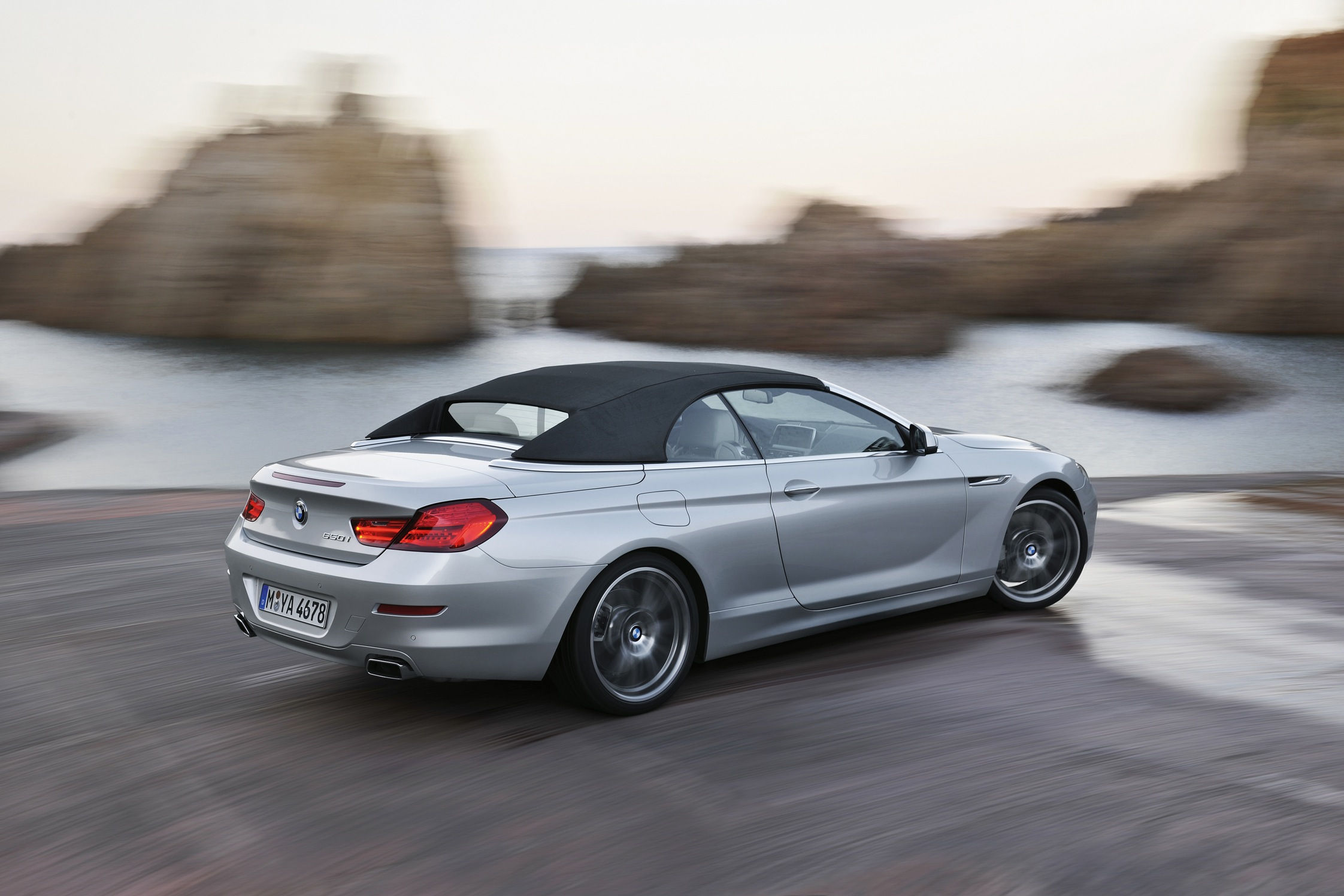 Wallpaper #VkVolo4B7YBJg1BVLqAC2 A Silver BMW 6 Series Convertible Driving on a Coastal Road