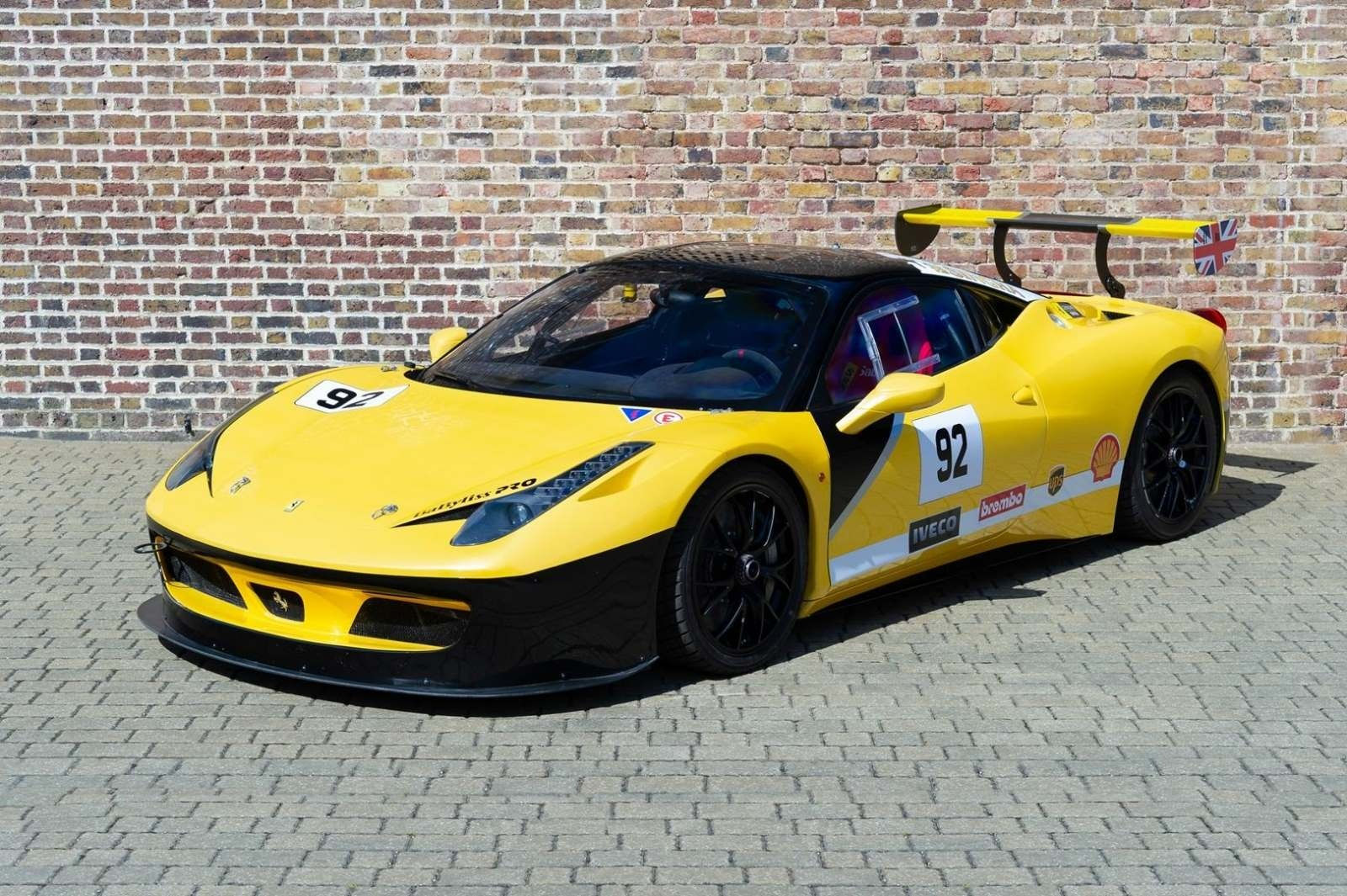 Wallpaper #53NJh44BFI5NbQkspCDD35 Yellow Ferrari 458 Challenge Race Car with a Large Rear Wing