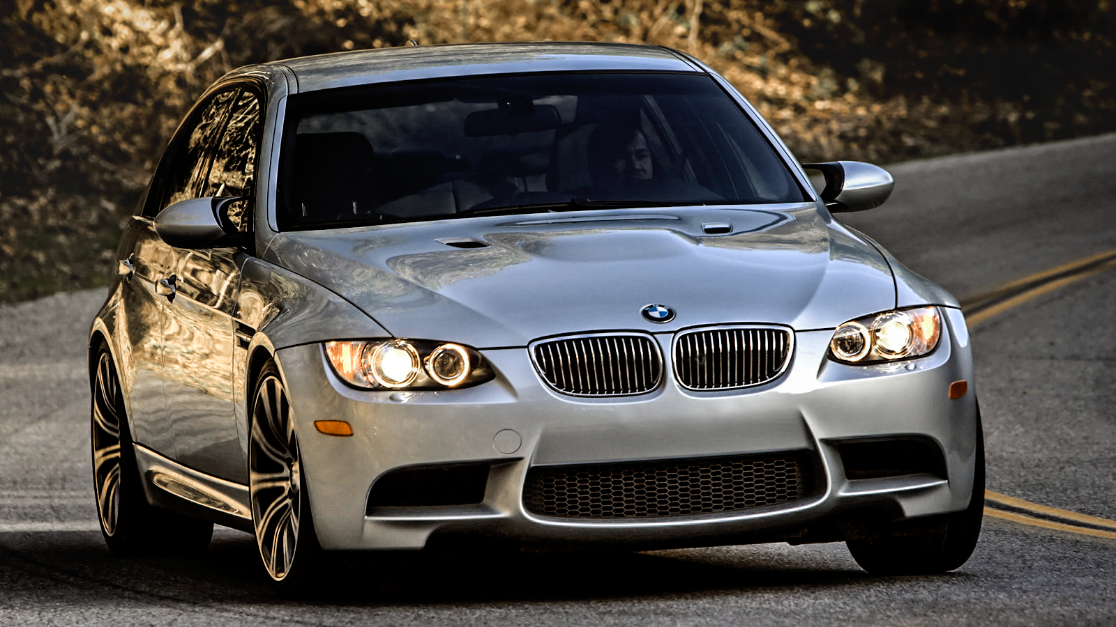 Wallpaper #TxVOtY4BmMigT4UnElNR42 A Silver BMW M3 E92 Model Car on an Asphalt Road