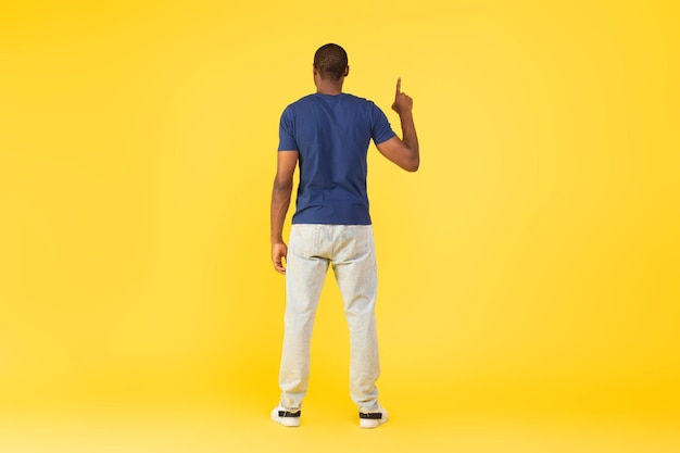 Wallpaper #IWf6_JIBSpphPi3-lZoB61 Premium Photo Back View of Black Guy Pointing Finger Upward Yellow
