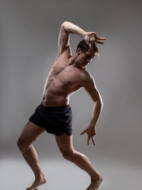 Wallpaper #-bkg3pIBJvJKYCmEzgMB352 Premium Photo Young Muscular Man in an Expressive Pose Artistic Pose