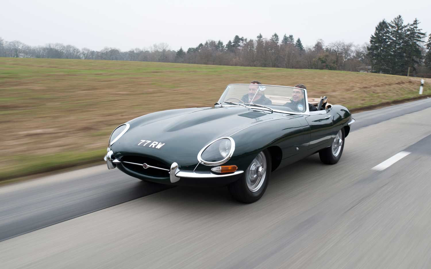 Wallpaper #_3MOho4BFI5NbQksfx5p55 A Classic Jaguar E-Type Speeding Down a Country Road