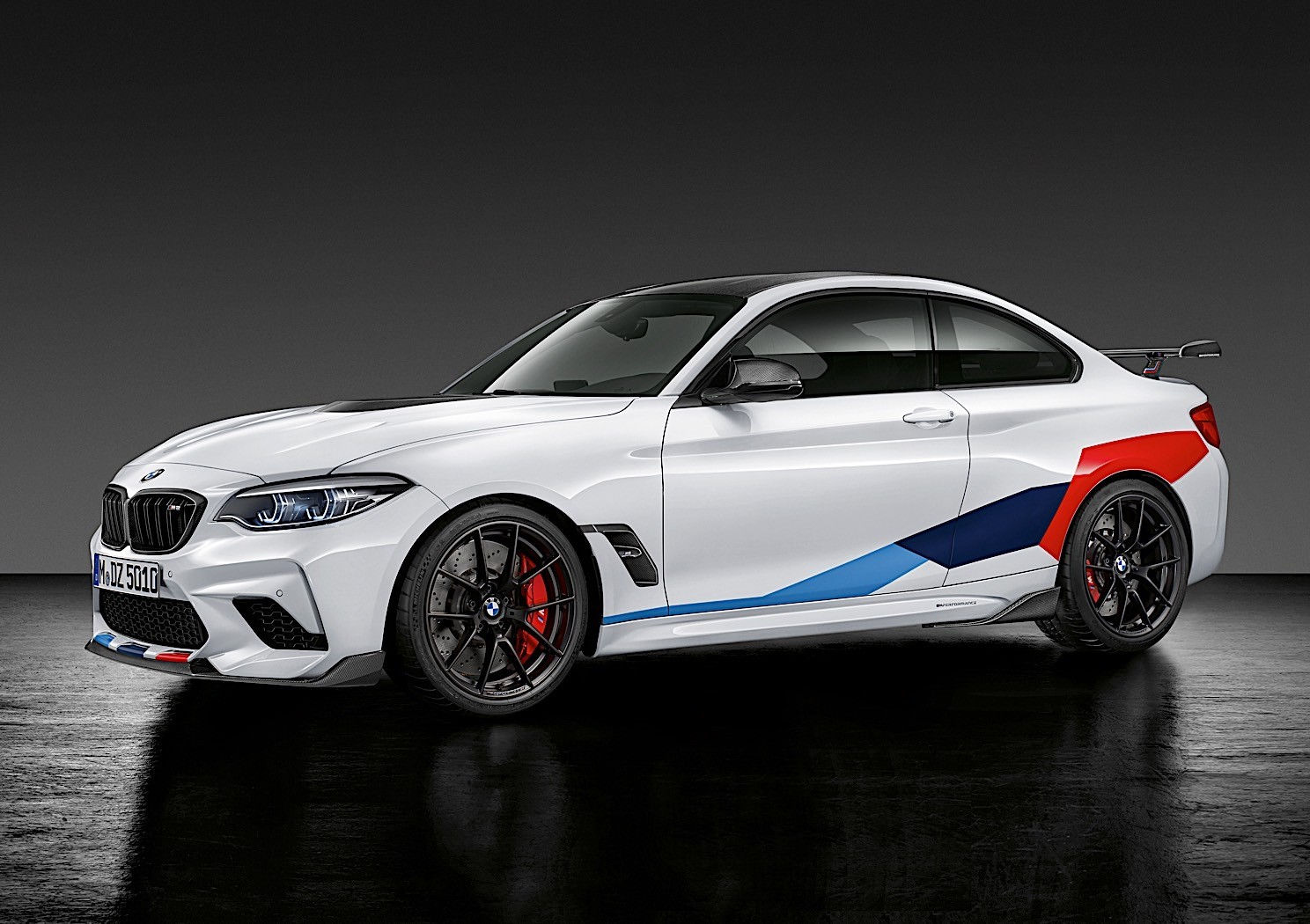 Wallpaper #C3M6gI4BFI5NbQksUhiD27 A Sleek White BMW M2 Competition with a Colorful Racing Stripe