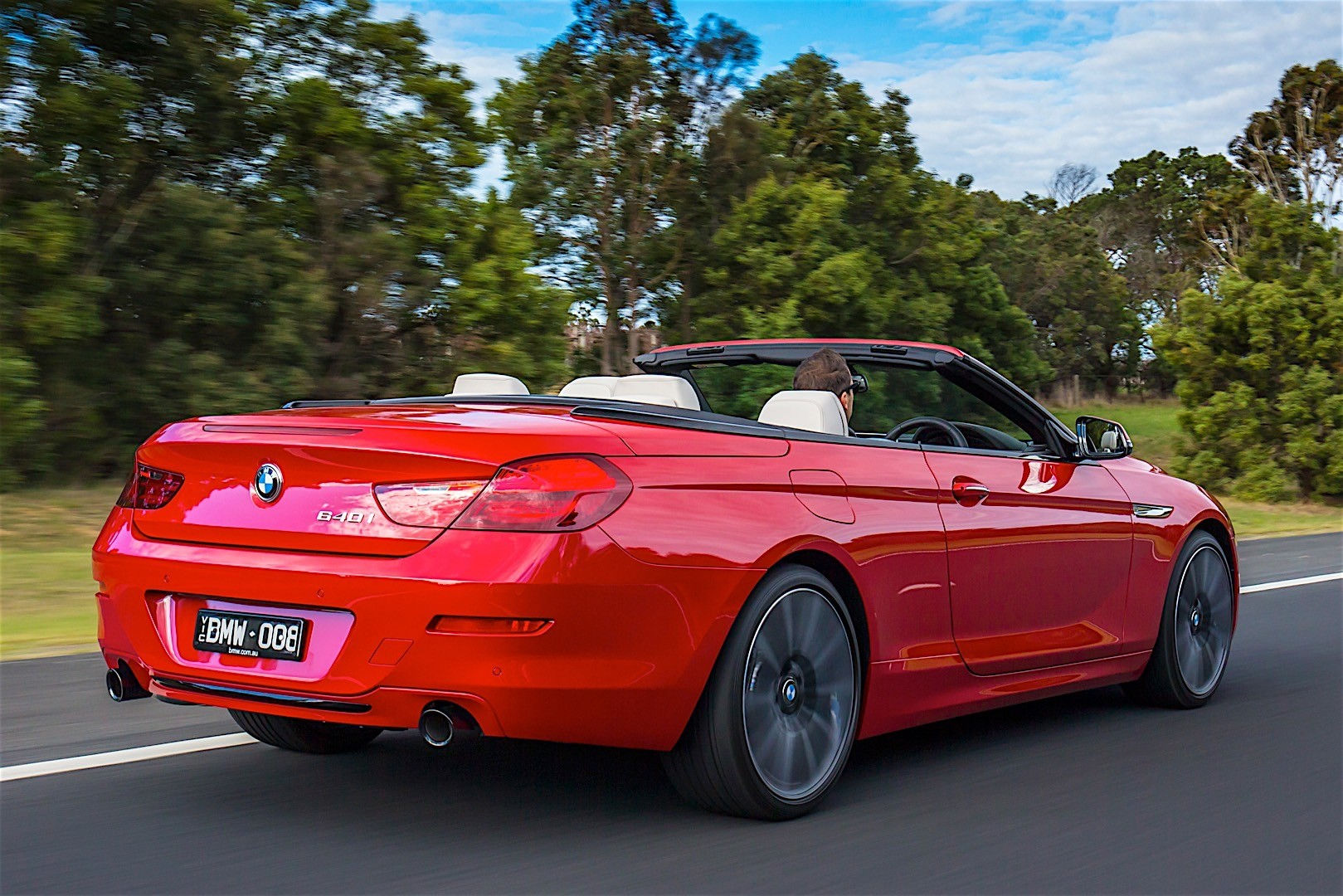 Wallpaper #VkVolo4B7YBJg1BVLqAC25 A Red BMW 6 Series Convertible Driving on a Winding Road