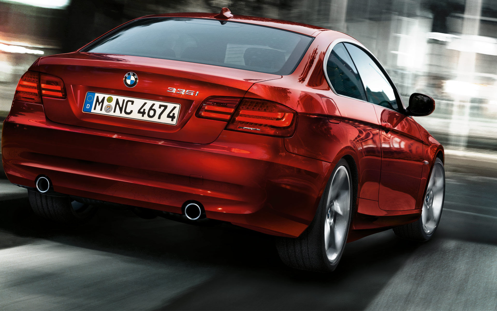 Wallpaper #lUW_oo4B7YBJg1BVBqSA17 A Red BMW Drives Down a City Street