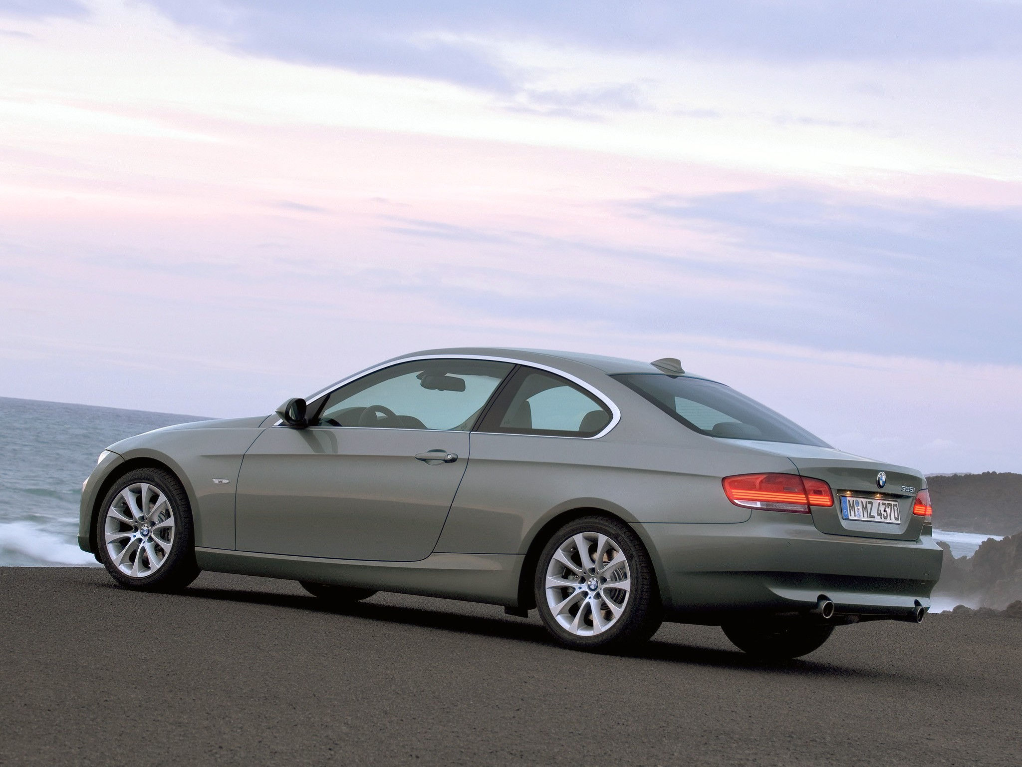 Wallpaper #lUW_oo4B7YBJg1BVBqSA25 A Silver BMW 3-Series Coupe Parked on a Coastal Road
