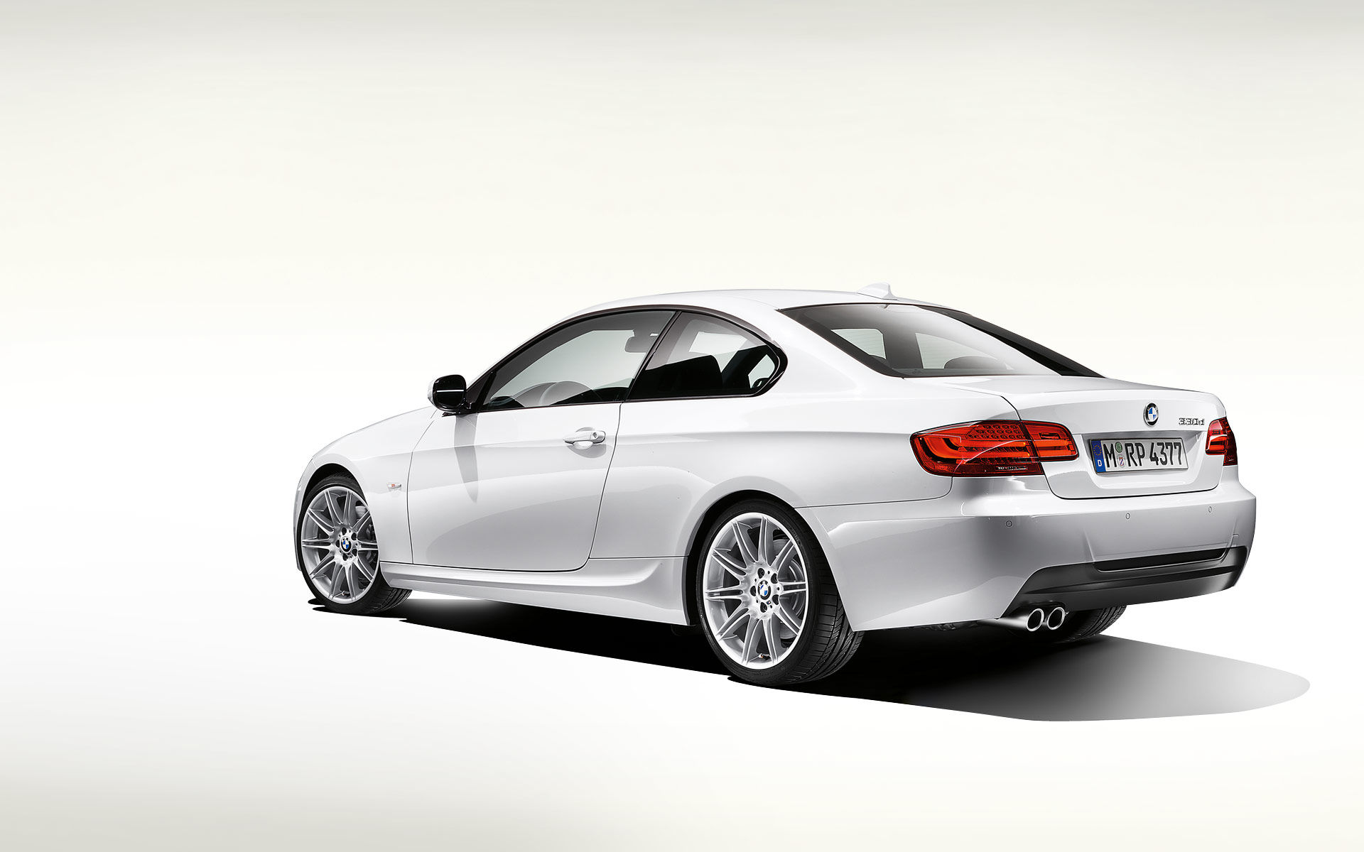 Wallpaper #lUW_oo4B7YBJg1BVBqSA9 A Sleek White BMW Coupe Parked on a White Background