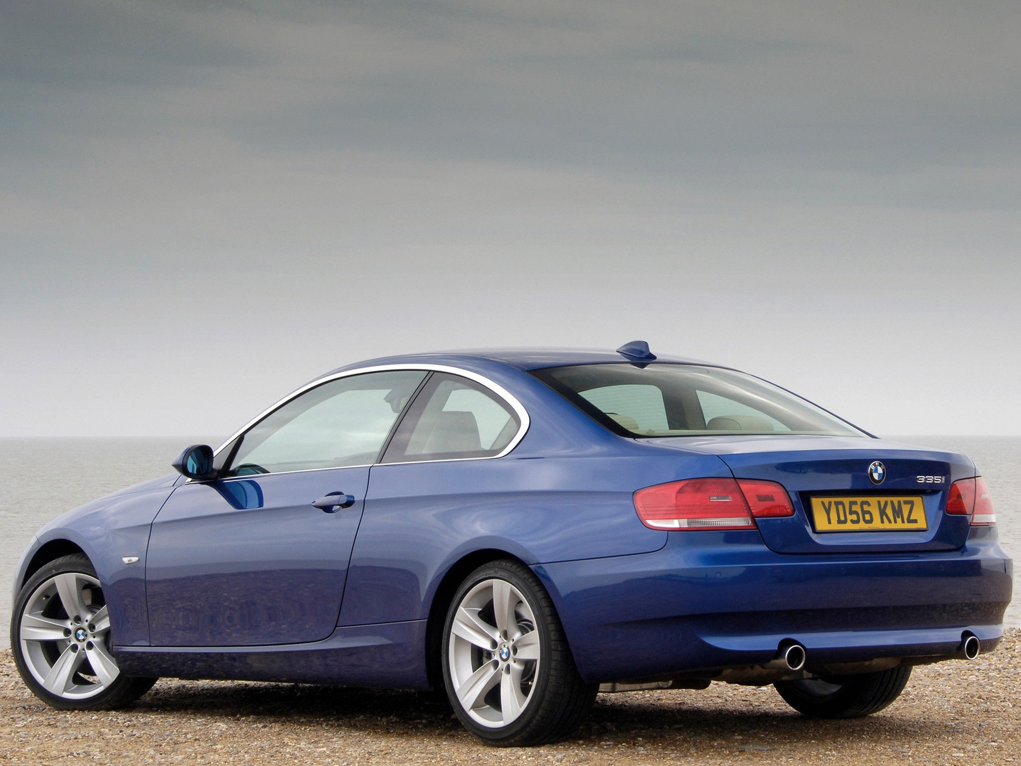 Wallpaper #lUW_oo4B7YBJg1BVBqSA7 A Sleek Blue BMW Parked on the Beach