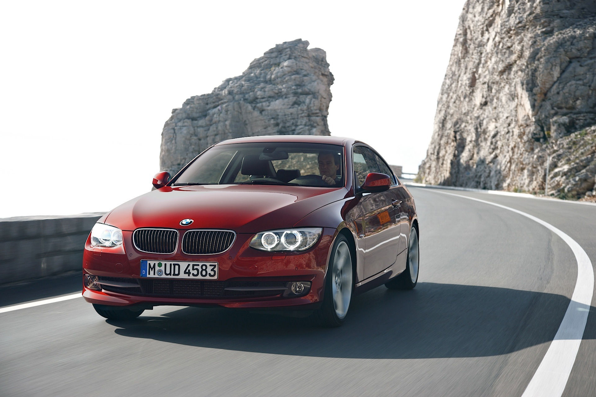 Wallpaper #lUW_oo4B7YBJg1BVBqSA46 A Red BMW Coupe Driving on a Winding Road
