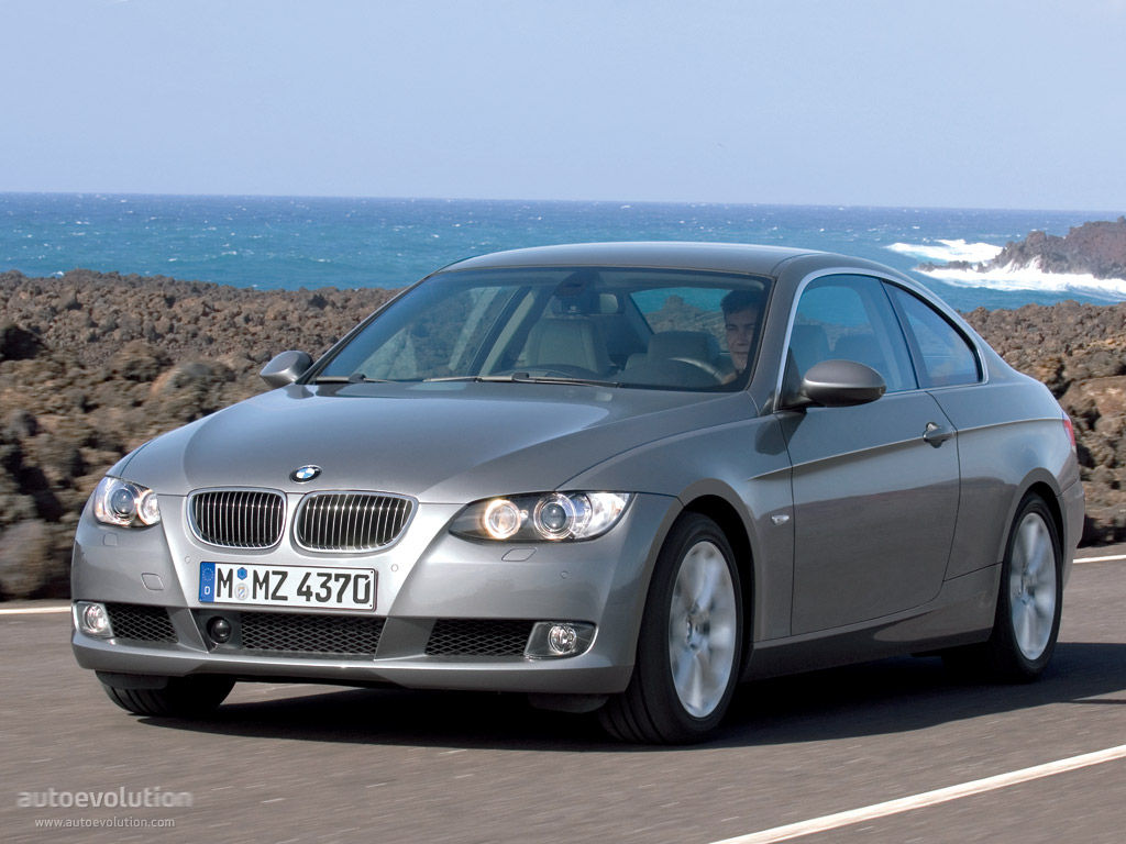 Wallpaper #lUW_oo4B7YBJg1BVBqSA33 A Silver BMW 3-Series Coupe Drives Along a Coastal Road