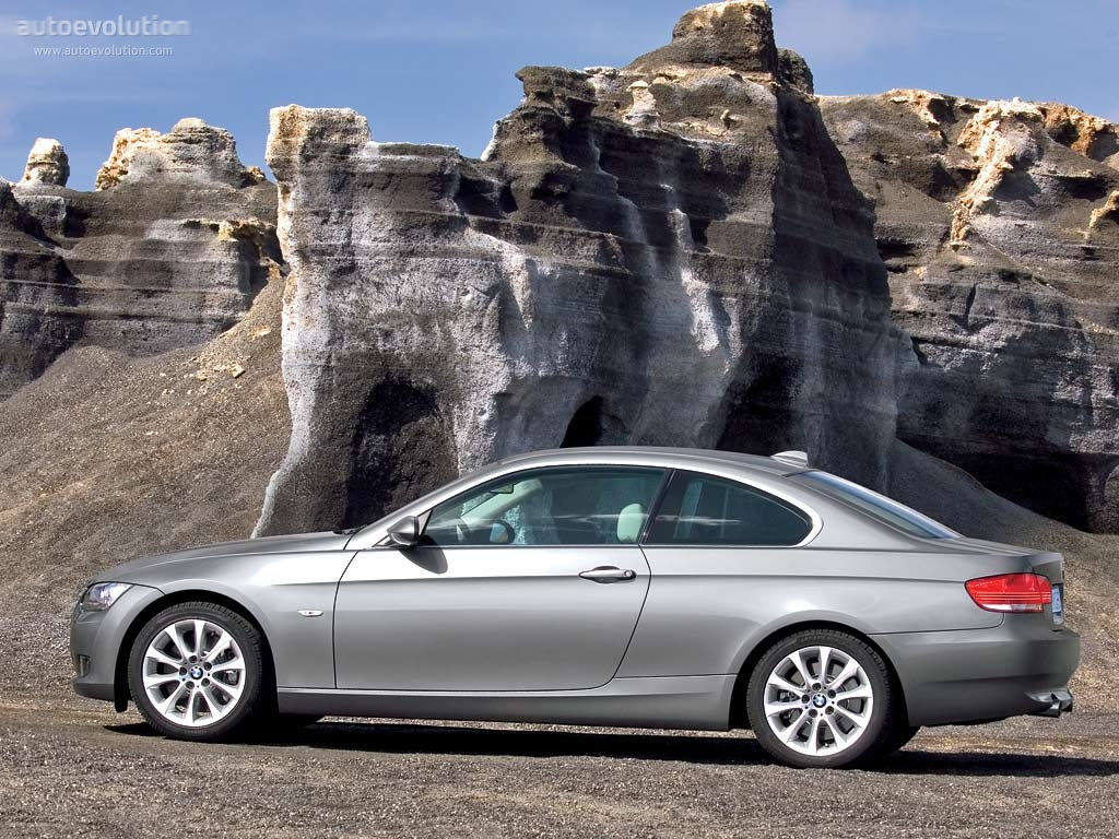 Wallpaper #lUW_oo4B7YBJg1BVBqSA41 A Silver BMW 3-Series Coupe Parked in Front of a Rock Formation