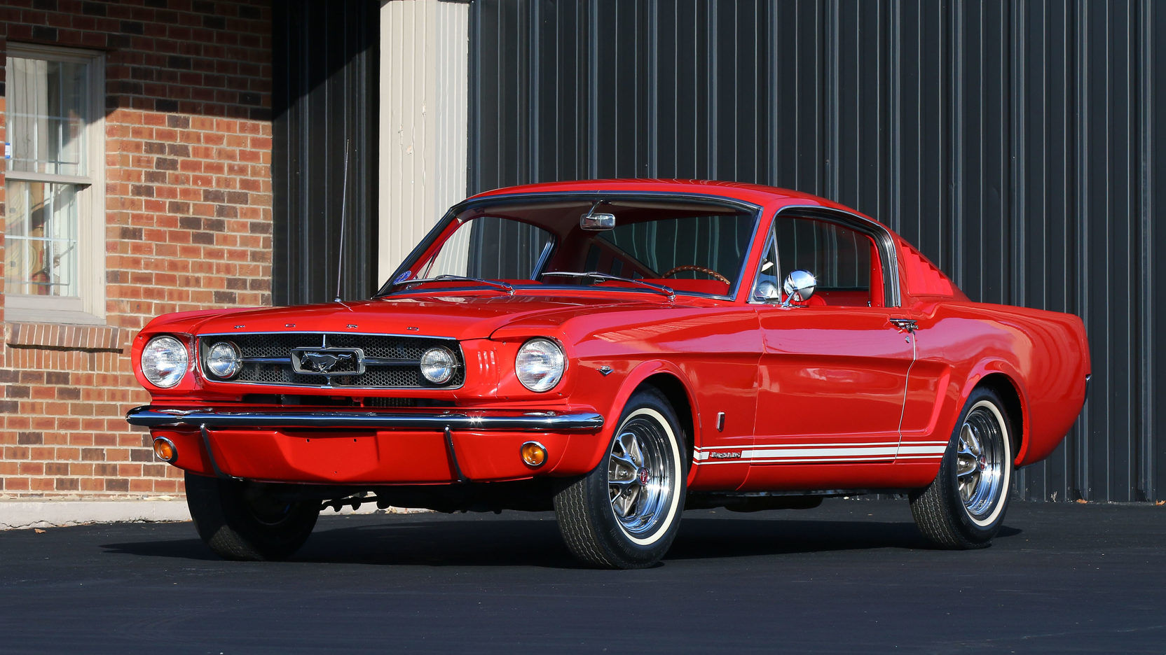 Wallpaper #_3MOho4BFI5NbQksfx5p28 A Red Ford Mustang Parked in Front of a Brick Building