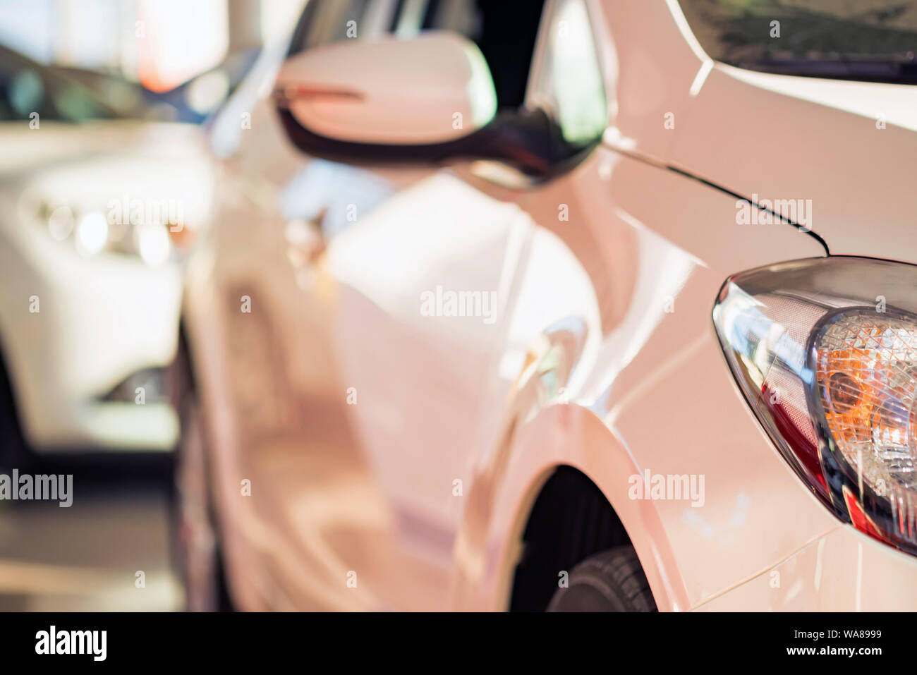 Wallpaper #JR3OK5MBlOZrFDOkKslm380 Stock of Cars in Showroom of Automobile Dealer with Blurred Background