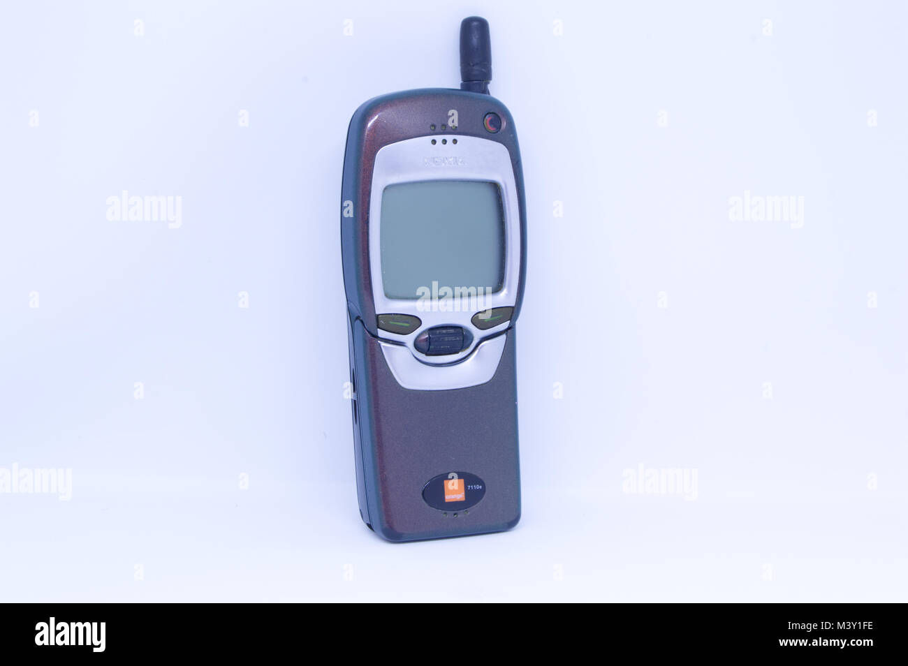 Wallpaper #hiatmJcBNyflpn9rtocD26 Old Nokia 7110 Mobile Phone with Flip Keypad Pictured Against a White