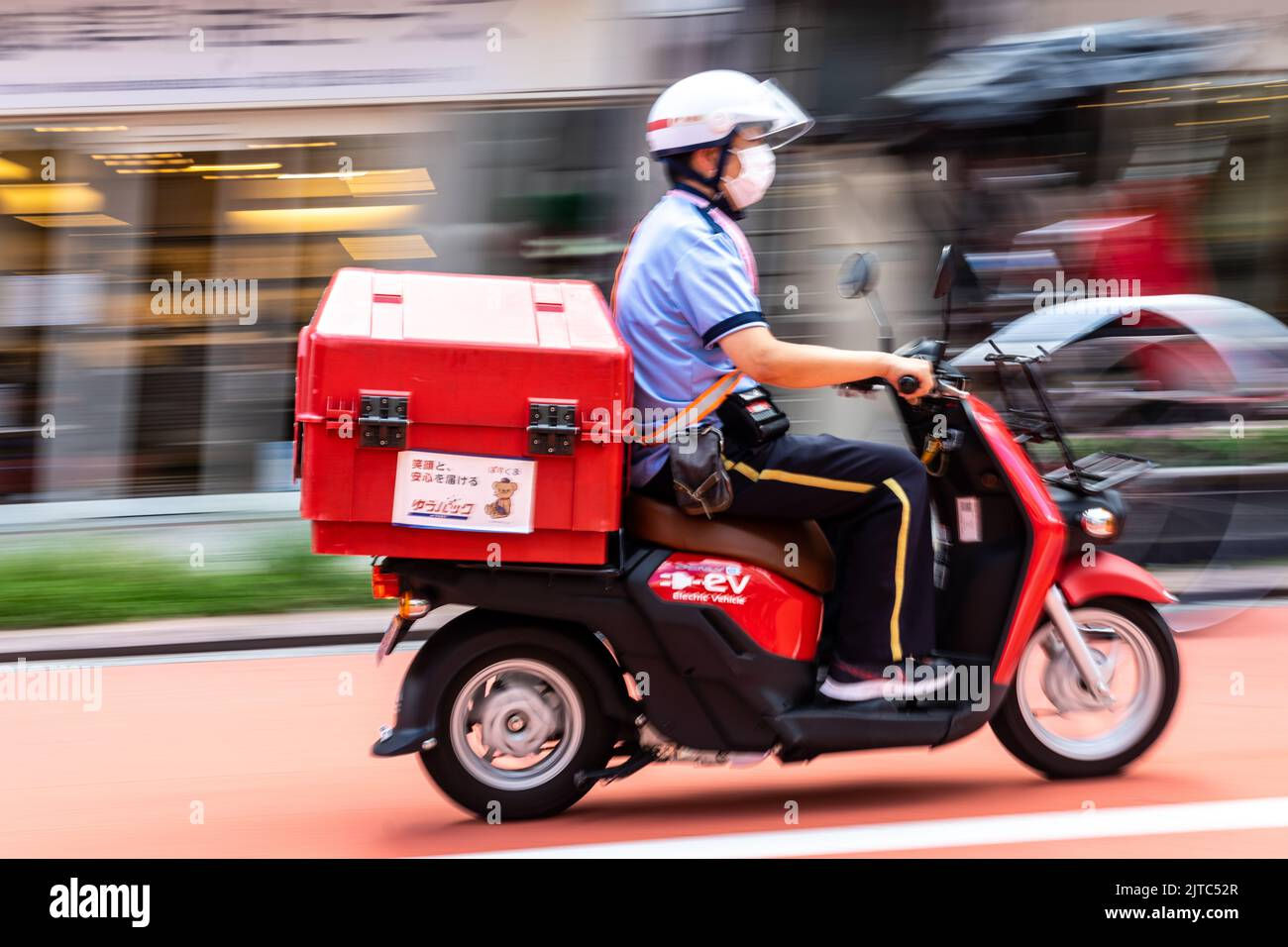 Wallpaper #wuqLUpMBlwTYPL18Cgn-248 A Japanese Postal Worker Delivers Mail by Electric Delivery Scooter