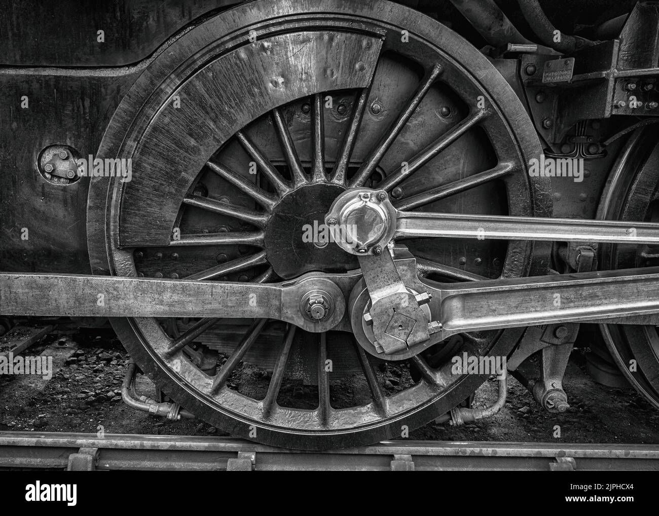 Wallpaper #1mfeBJMBSpphPi3-LLnJ563 Black and White Image of Large Steel Wheels on a Steam Engine at the