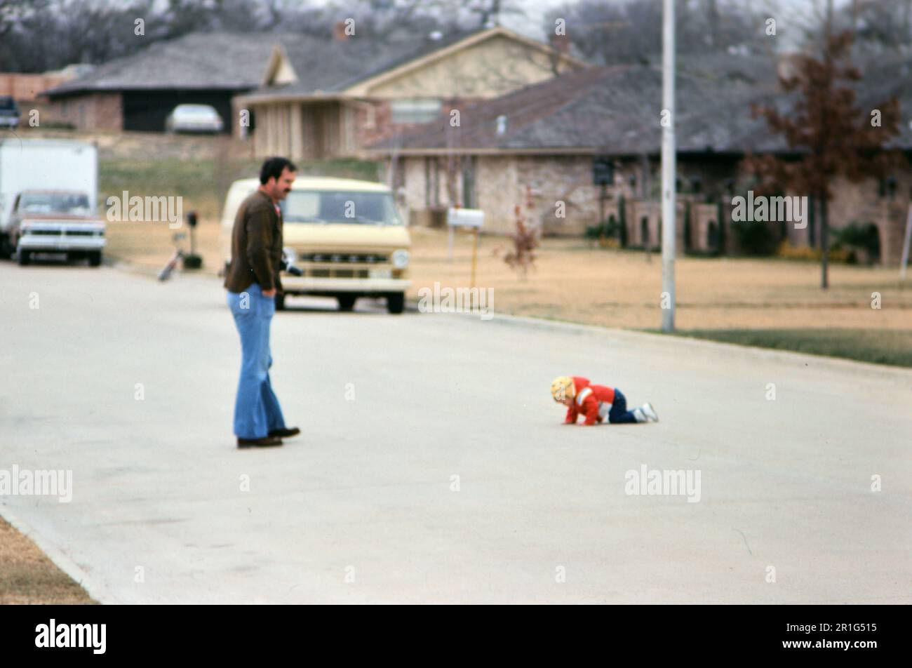 Wallpaper #9mdFCpMBSpphPi3-NNO0282 Father Watching His Infant Child Crawl in the Middle of a Street in a