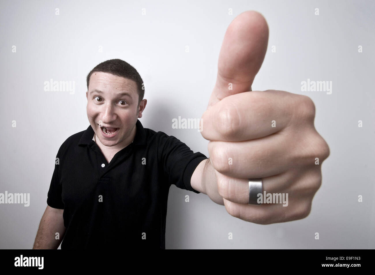 Wallpaper #L1hZNJMBzN9vxX34tTwG215 A Man Gives a Giant Thumbs Up to the Camera Stock Photo Alamy