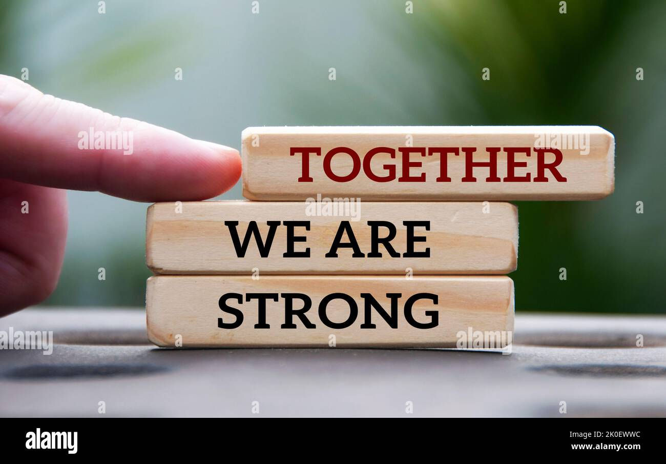 Wallpaper #_GfQEZMBSpphPi3-c_iD14 Finger Pointing Together We Are Strong Text on Wooden Blocks with