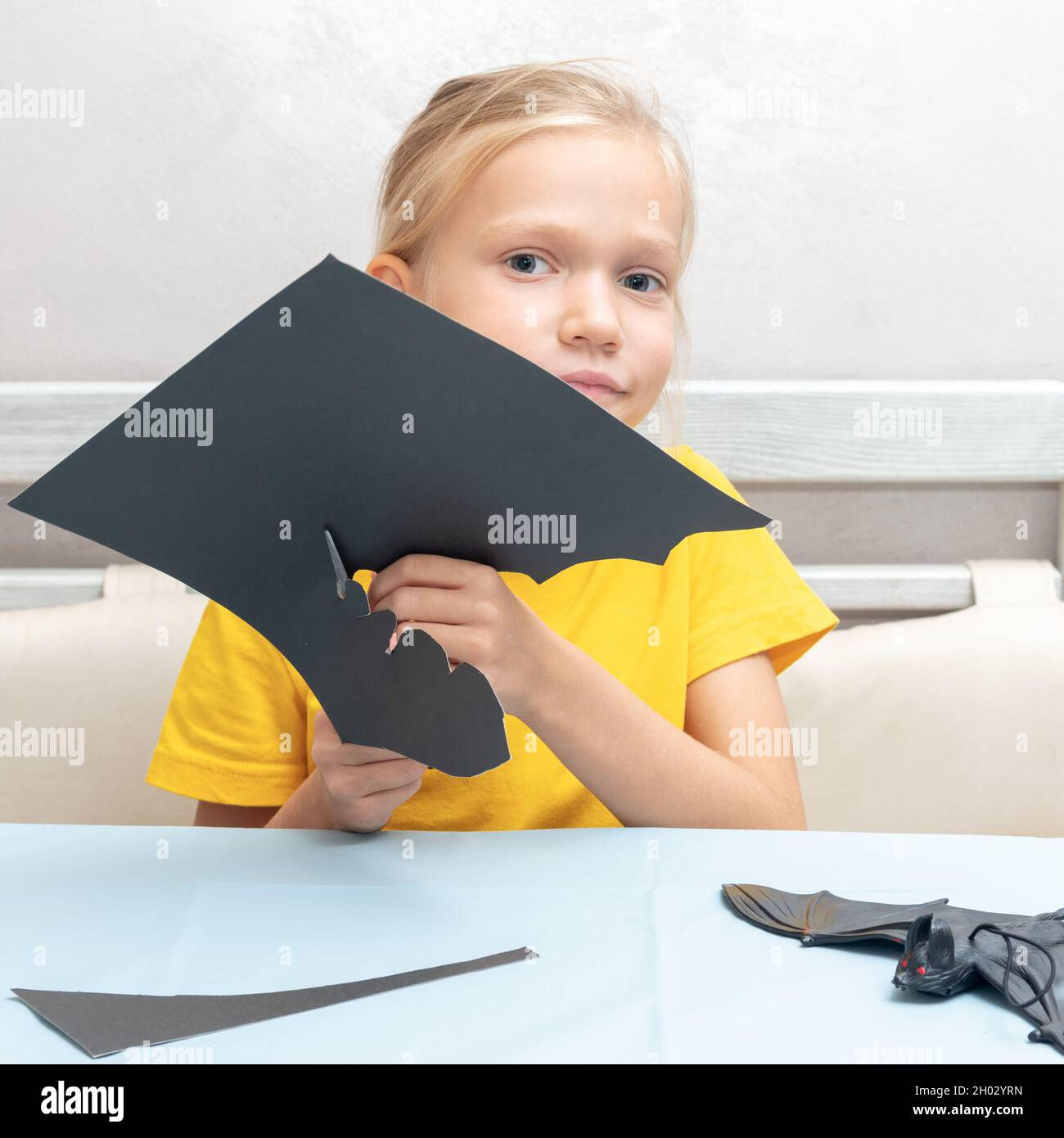 Wallpaper #lQMqZpMBpyOg8YnE0dqs282 A Girl Cuts a Halloween Decoration at Home from Black Paper Diy Craft