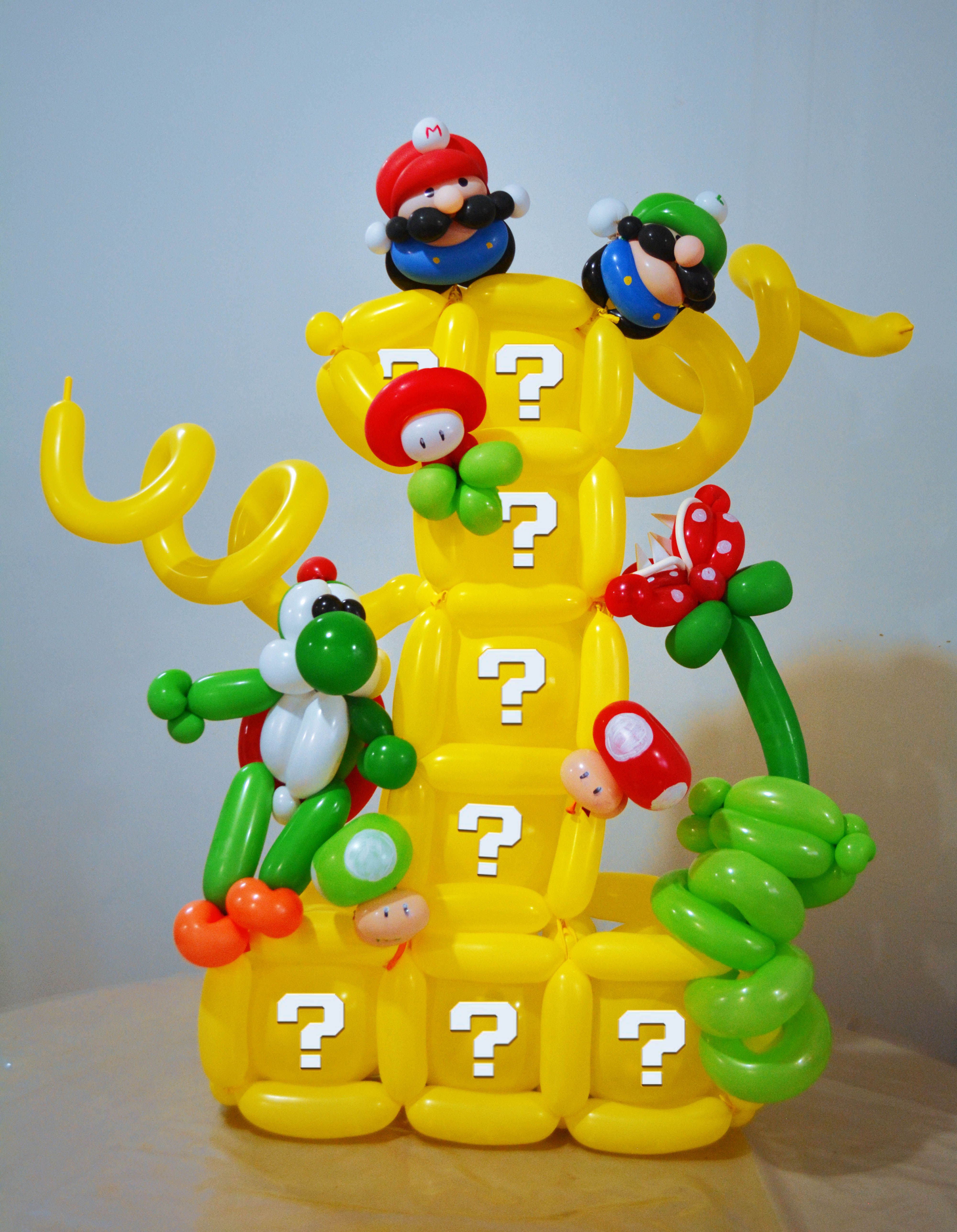 Wallpaper #Kx3VLZMBlOZrFDOkdNK0301 An Inflatable Toy with Mario and Luigi on It Sitting on a Wooden Table