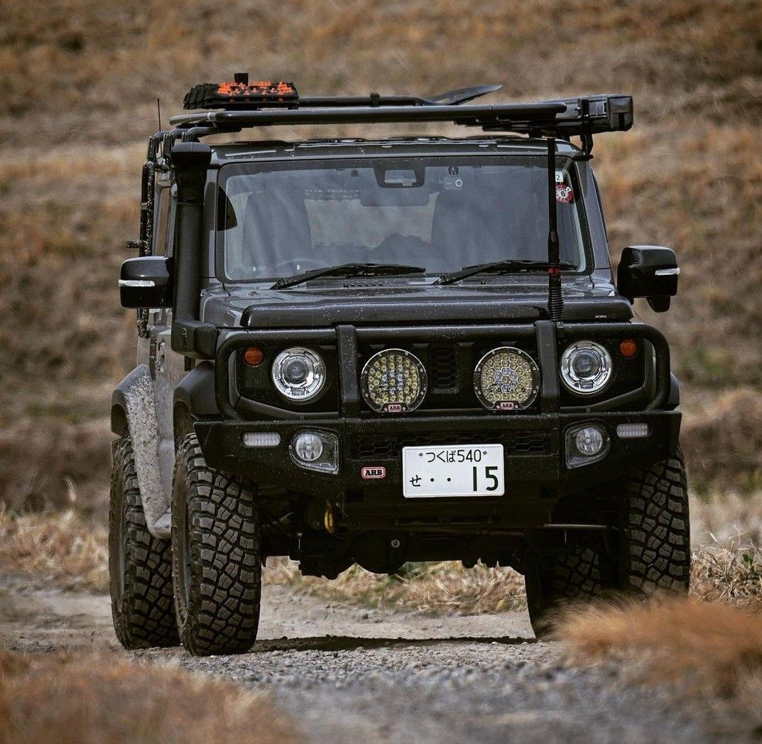 Wallpaper #xmfK55IBSpphPi3-yzmm260 The Front End of a Black Four Door Jeep Driving on a Dirt Road with