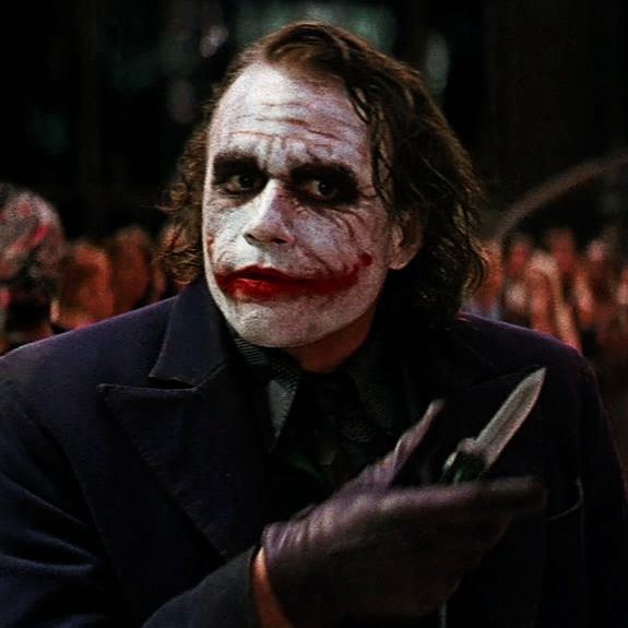 Wallpaper #pLg525IBJvJKYCmE3_XP361 A Man Dressed as the Joker Holding a Pair of Scissors