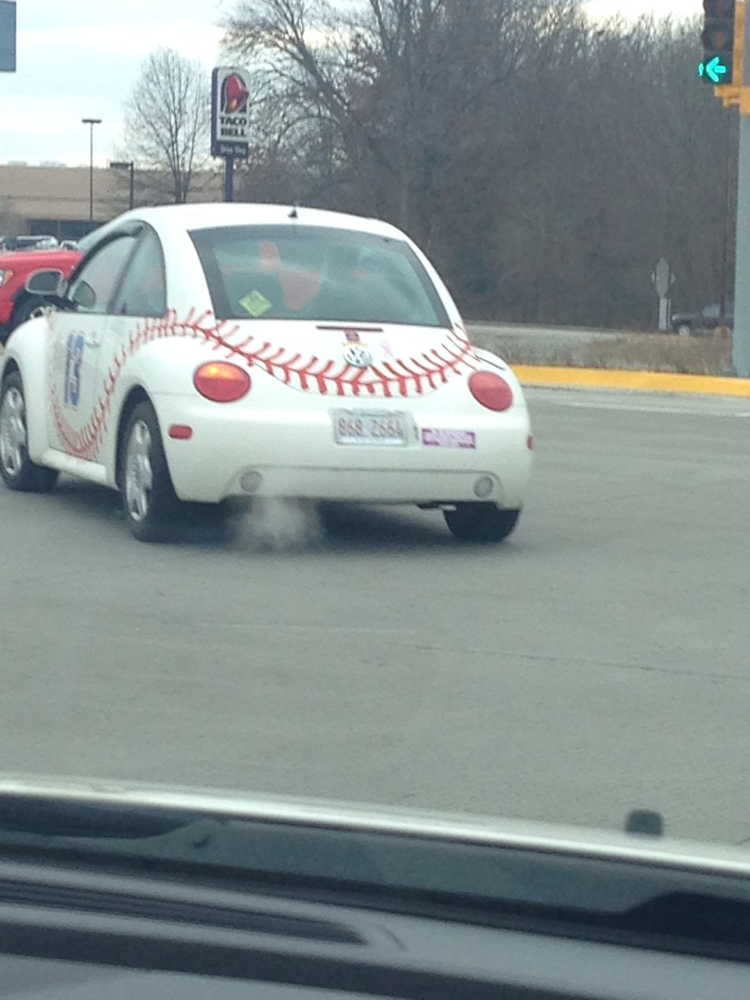 Wallpaper #T9dFMpMB4Oq-IITv5zbD345 A Car That is Sitting in the Street with a Baseball on Its Hood