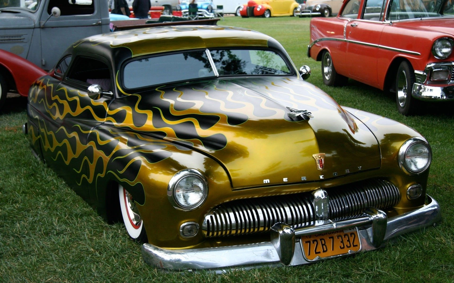 Wallpaper #_3MOho4BFI5NbQksfx5p54 A Golden Hot Rod with Flames Painted on the Hood