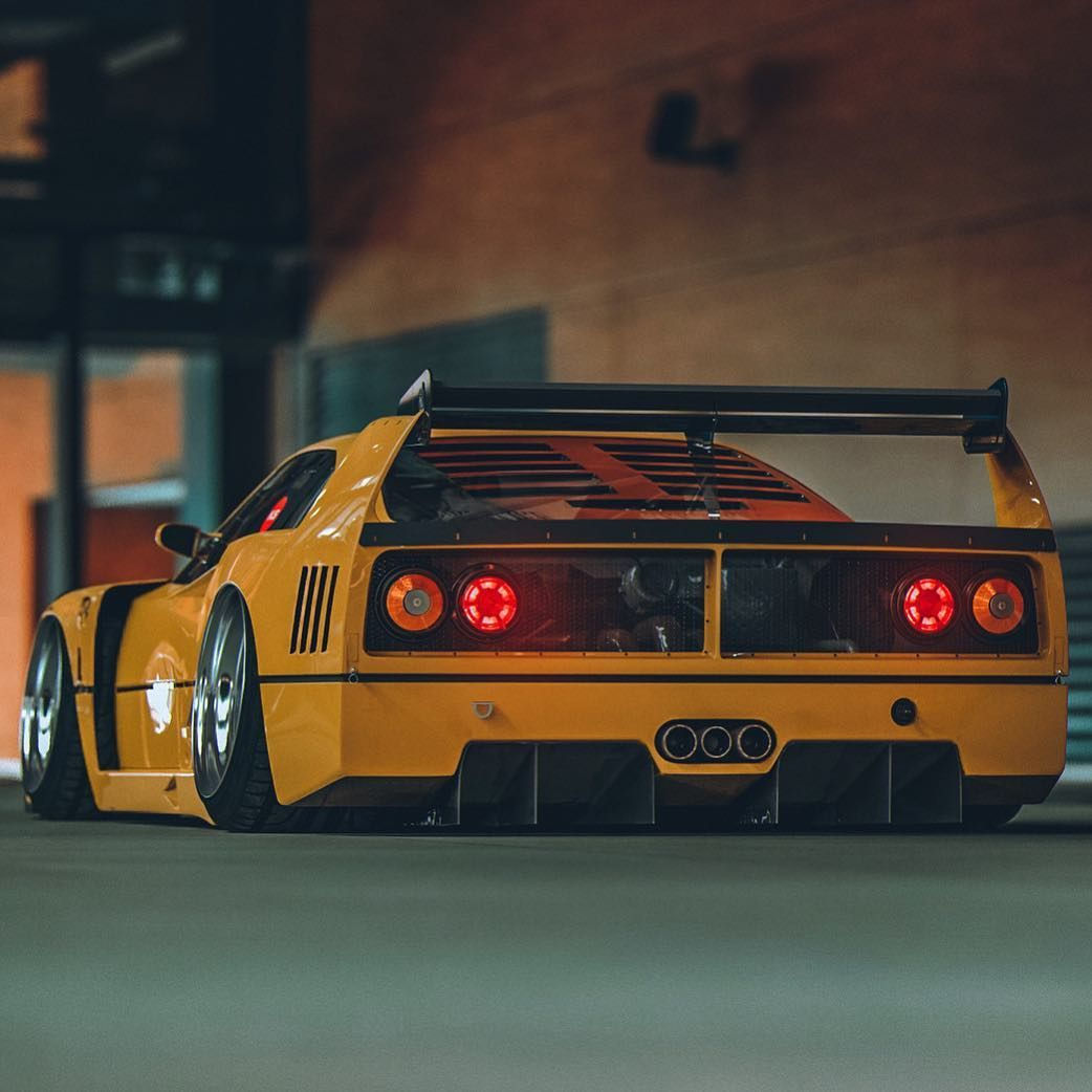 Wallpaper #K3OBh44BFI5NbQksaSEI22 A Yellow Ferrari F40 with a Large Rear Wing and Black Wheels