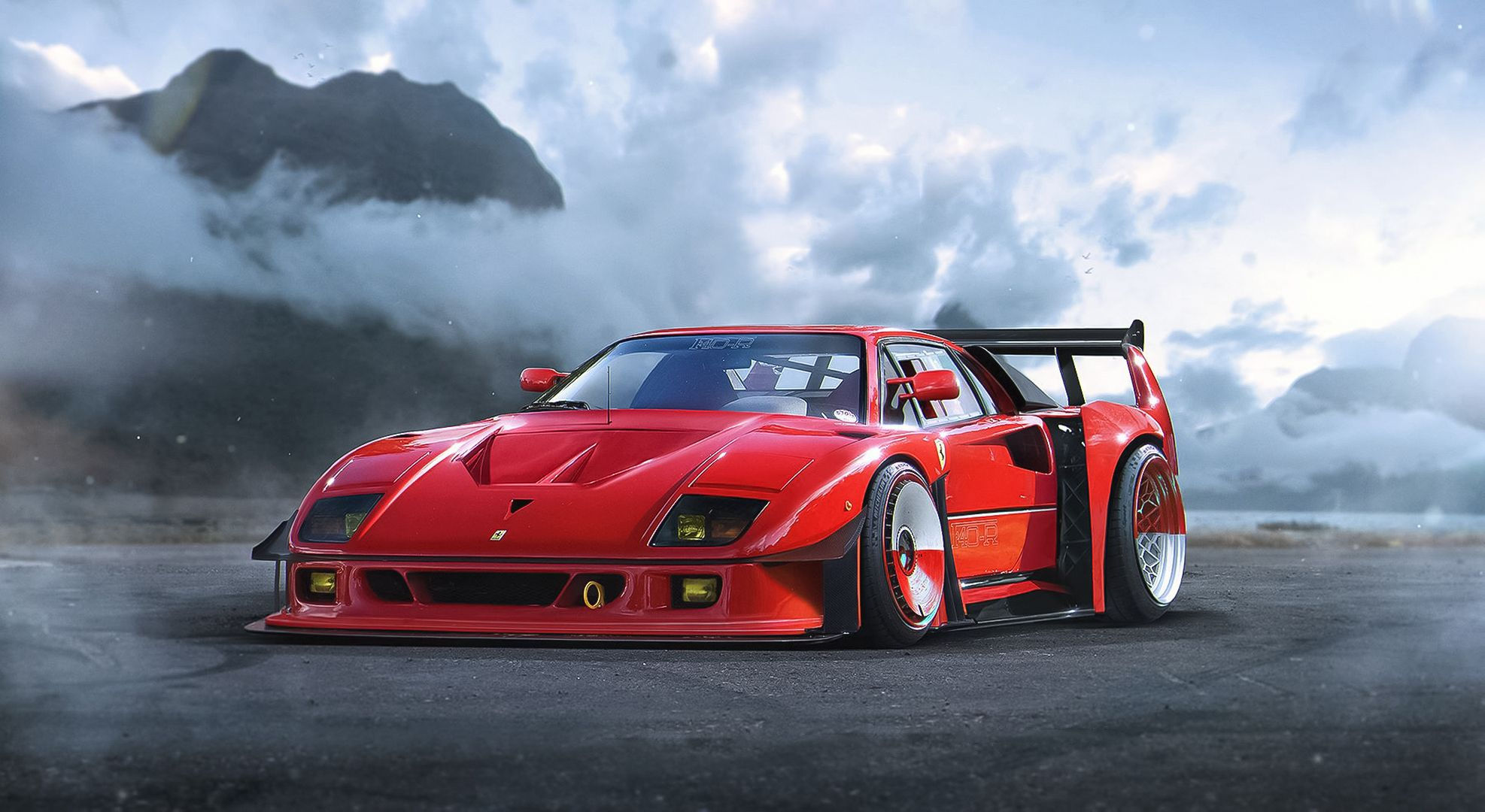 Wallpaper #XnMzio4BFI5NbQksnyJy50 A Red Ferrari F40 Driving on a Coastal Road with Mountains in the Background