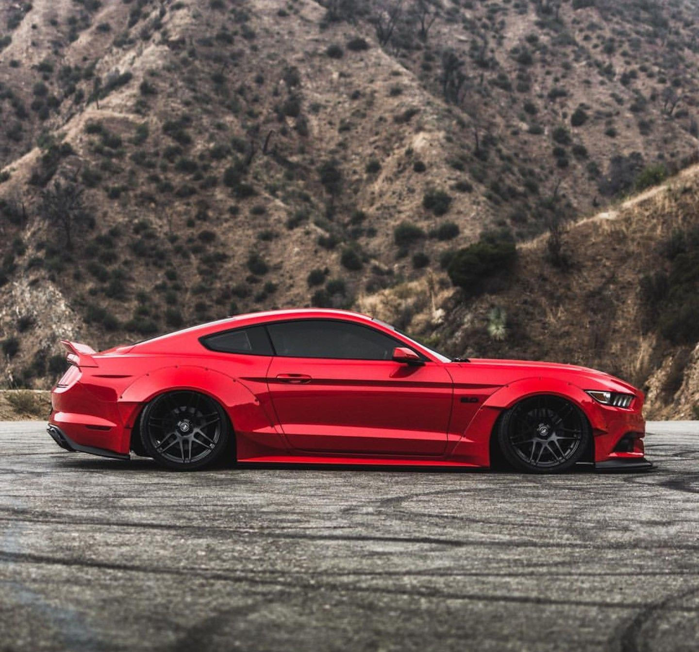 Wallpaper #TxooUZMB1yWOL4qgvoGk245 A Red Mustang Parked in Front of a Mountain
