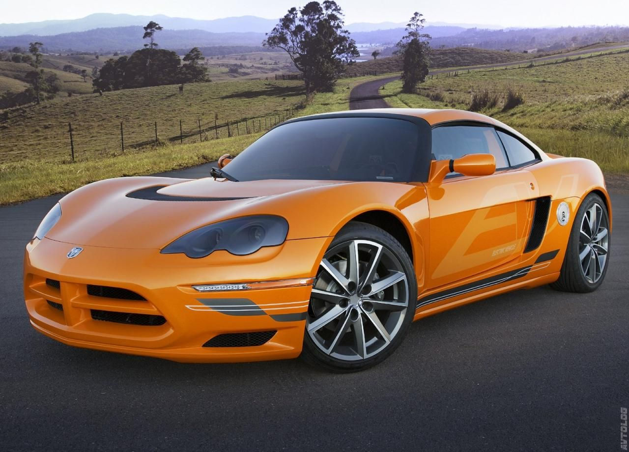 Wallpaper #-BWPso4BmMigT4UnP1FC32 A Sleek Orange Sports Car on an Empty Road