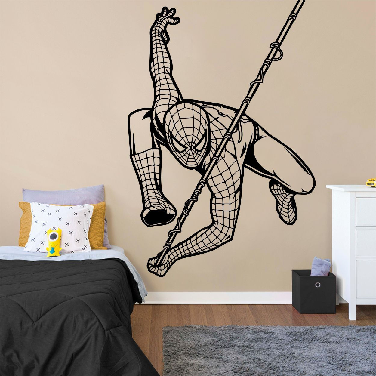 Wallpaper #O-pEV5MBlwTYPL18rBHC134 A Wall Decal with a Spiderman Swinging on a Pole in a Bedroom Area