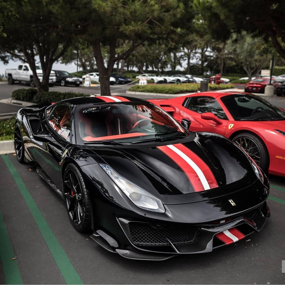 Wallpaper #cEVwoo4B7YBJg1BVF6Sg37 A Sleek Black Ferrari 488 Pista with Red Stripes Parked in a Parking Lot