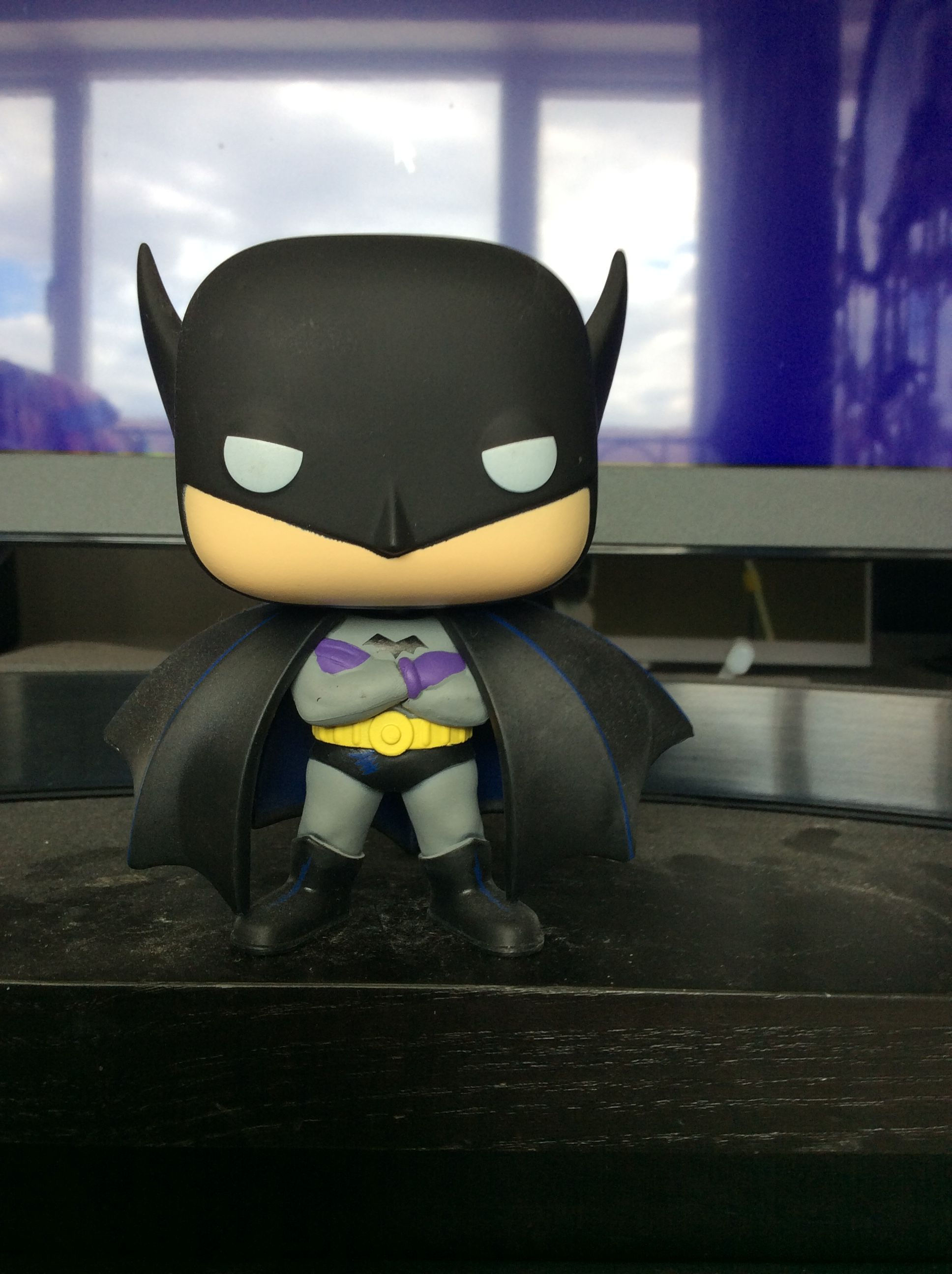 Wallpaper #Nn1E9I4Bnwiau_P6Pw-S39 A Batman Figurine Sitting on Top of a Desk
