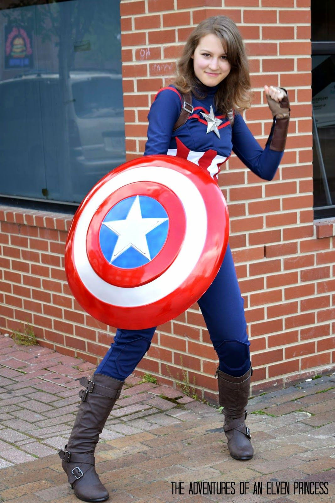 Wallpaper #dHN8io4BFI5NbQksQCIN22 A Young Woman Dressed as Captain America Poses in Front of a Brick Building